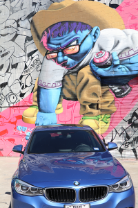Colorful mural and blue BMW in East Downtown, Houston, Texas